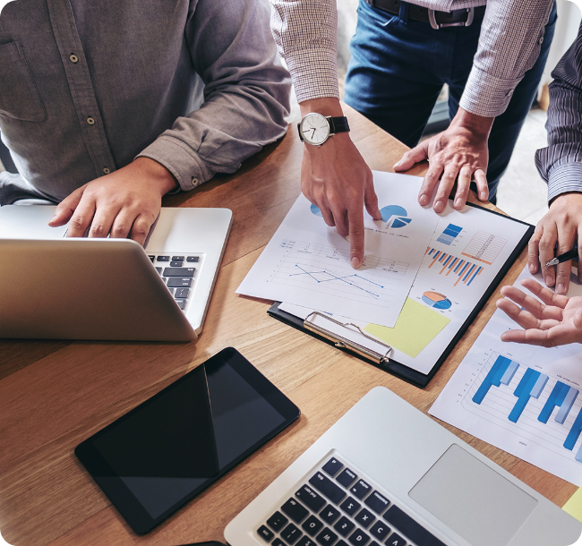 Accounting team reviewing financial reports and charts during a meeting. Accounting services in Singapore for bookkeeping and tax compliance.